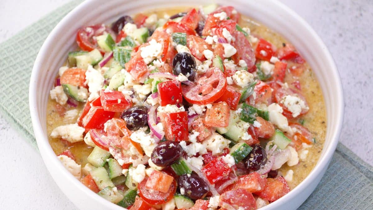 Mediterranean Cucumber Tomato
Salad in a single serving bowl resting on a green napkin.