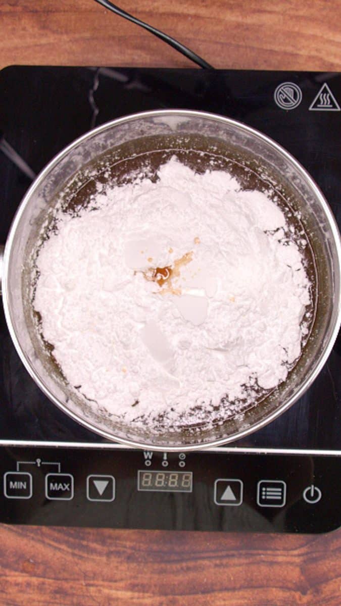 Powdered sugar added to melted butter and brown sugar to make cooked caramel Icing.