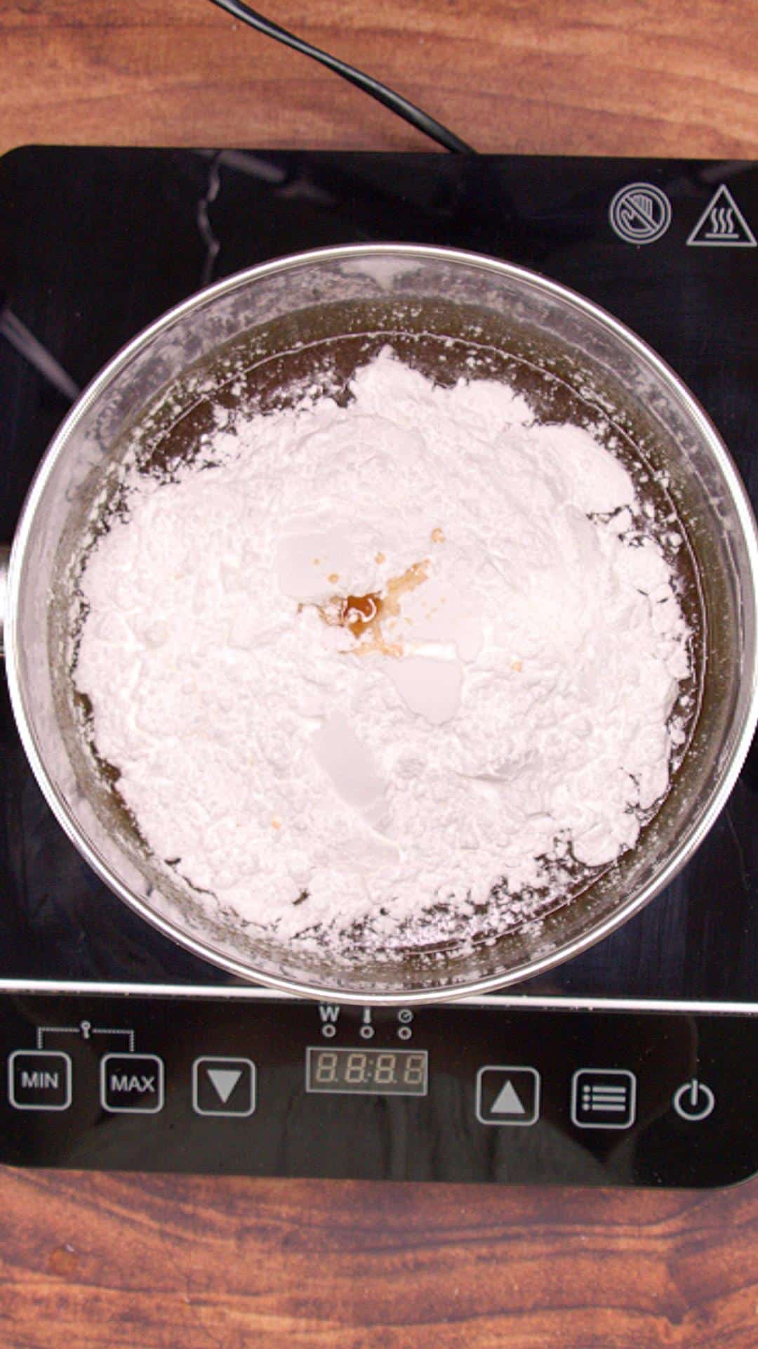Powdered sugar added to melted butter and brown sugar to make cooked caramel Icing.