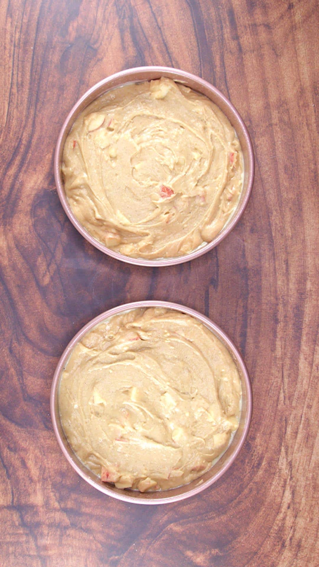 Two round cake pans filled with apple spice cake batter - Hostess At Heart