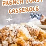 A front view of a baked French Toast Casserole serving dusted with powdered sugar.
