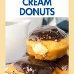 An image for Pinterest of stacked Boston Cream Donuts topped with chocolate ganache and with the cream filling oozing out of the side. Hostess At Heart