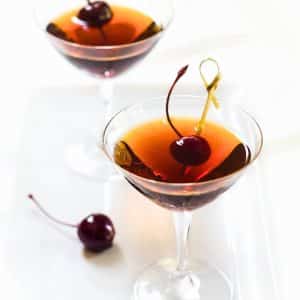 Front angle of a classic manhattan cocktail made with rum instead of whiskey - Hostess At Heart