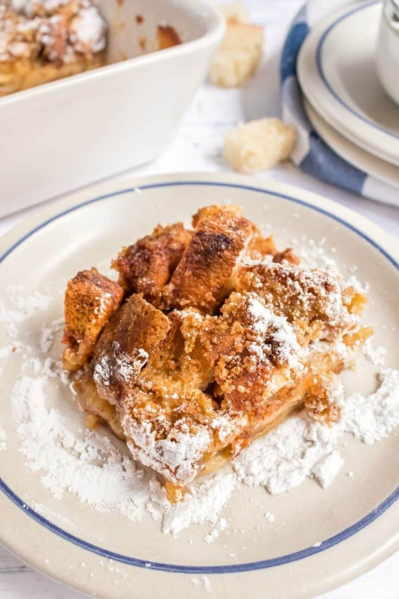 Angled view of a Brown Sugar French Toast casserole serving dusted with confectioners sugar. Hostess AT Heart