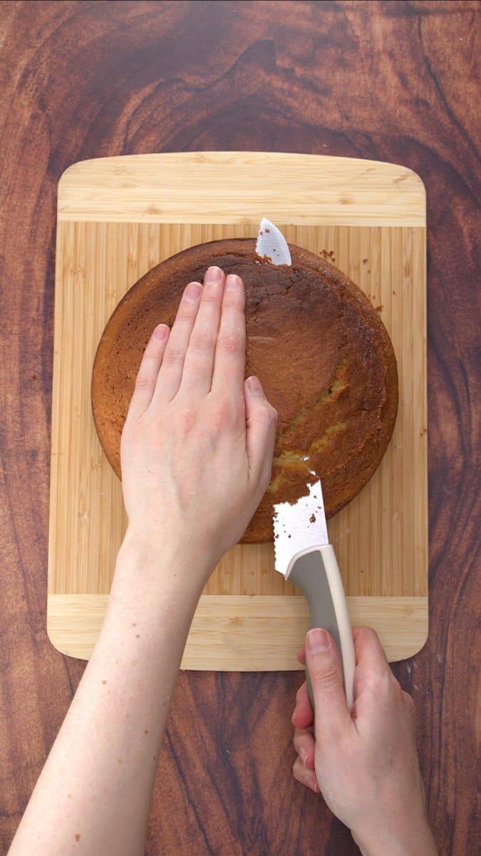 The top of a round cake being cut so that it's flat for layering - Hostess At Heart