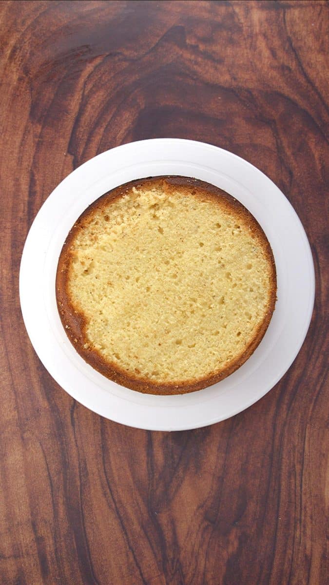 A round easy vanilla cake with the top sliced off so it's flat for layering. Hostess At Heart