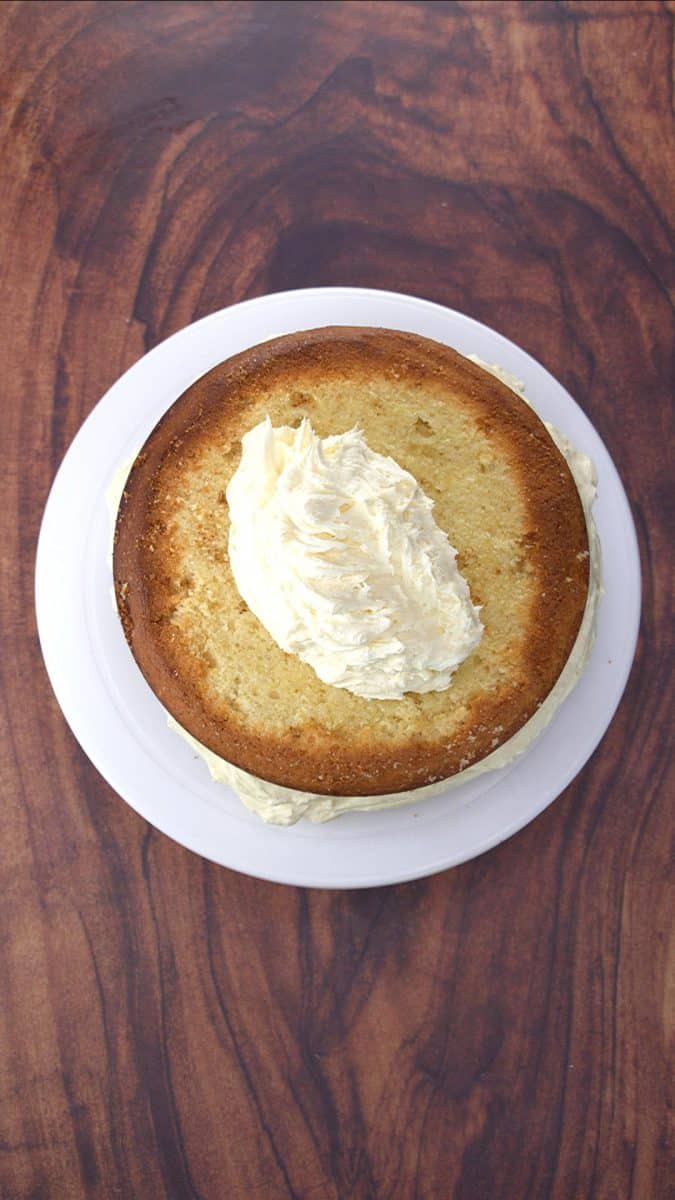 The second layer of a two layer vanilla cake recipe topping the first.