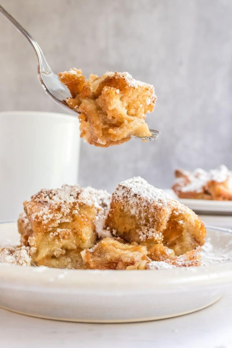 Tableview of a fork lifting a bite of French Toast Breakfast from a plate - Hostess At Heart
