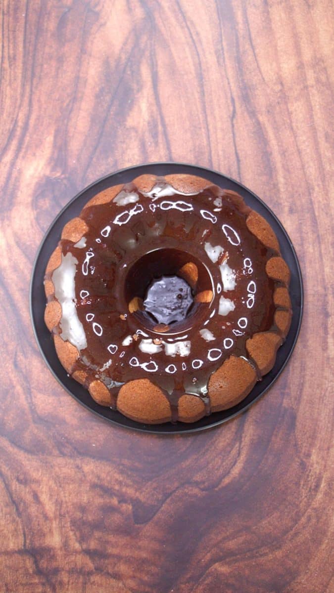 Top down view of a hersheys chocolate cake with chocolate glaze drizzled over the top and sides.
