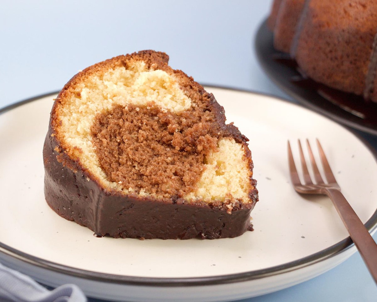 A plate holding a slice of chocolate syrup cake - Hostess At Heart