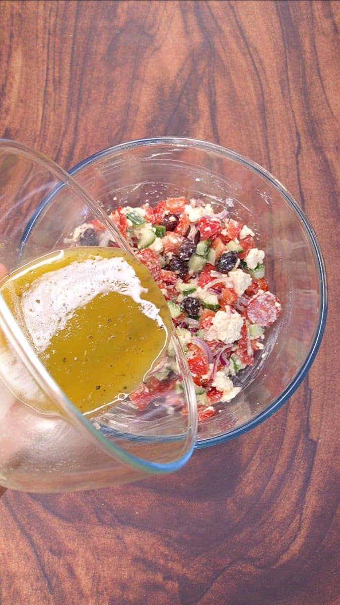 Adding the dressing to the chopped veggies. 