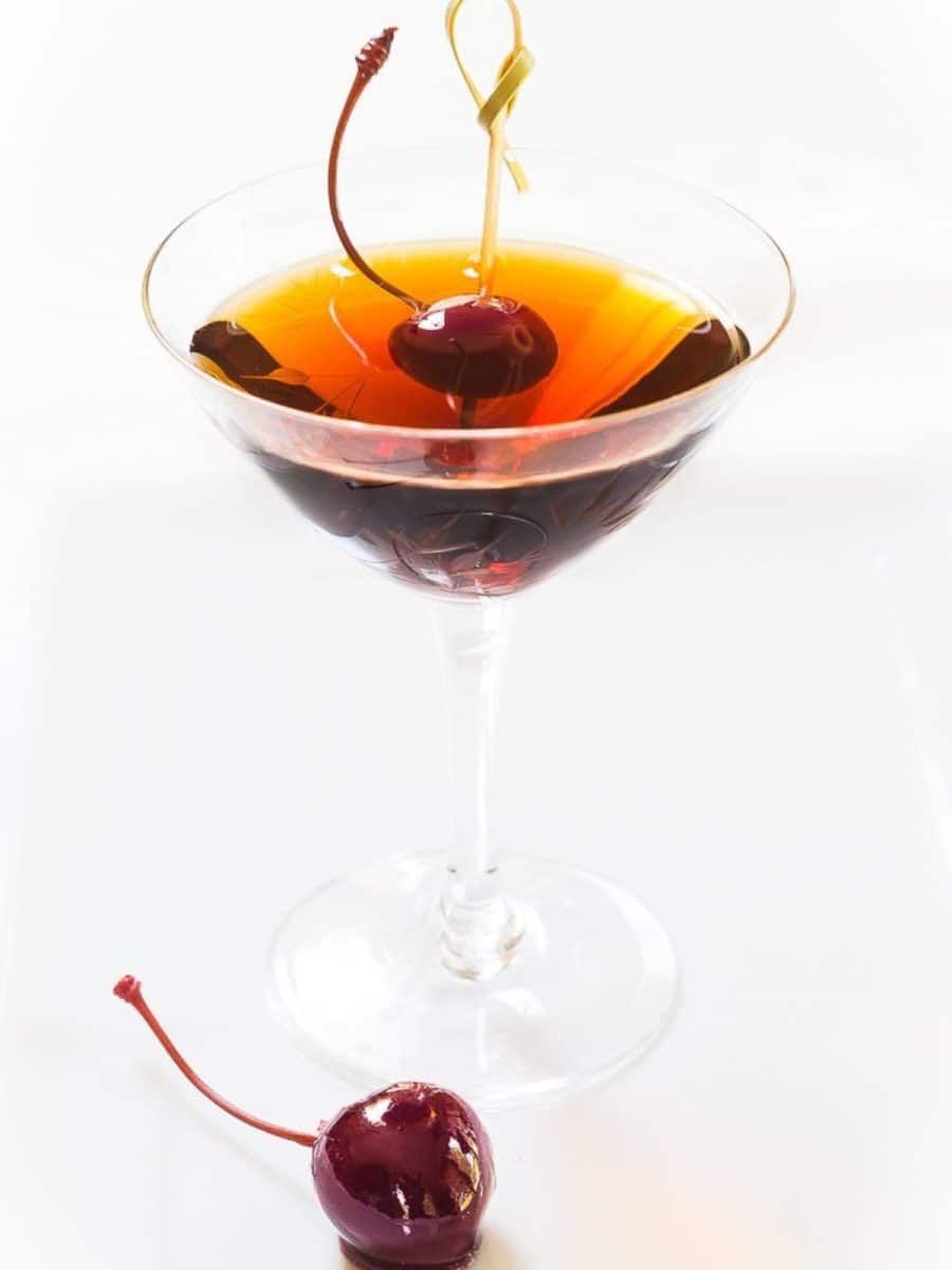 Front view of a Cuban cocktail made with rum in a coupe glass. Hostess At Heart