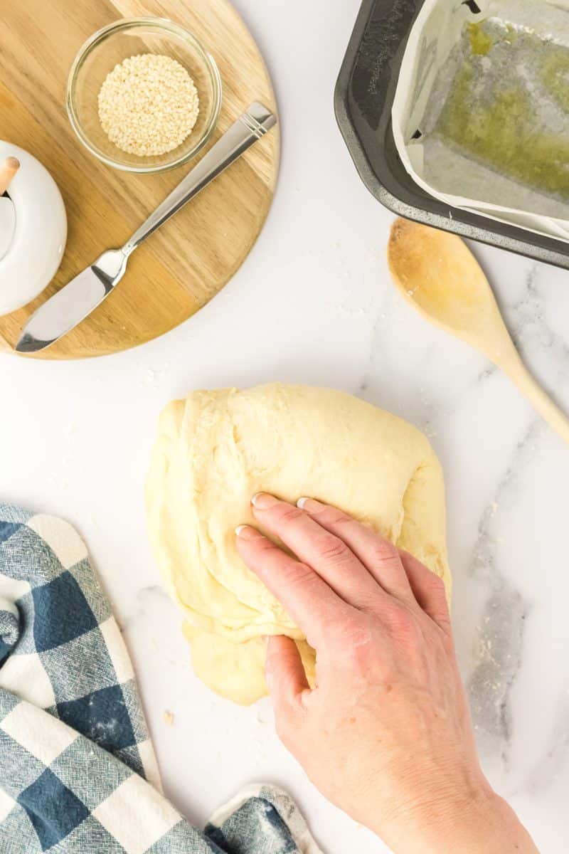 Sesame bread dough folded into a rectangle. Hostess At Heart