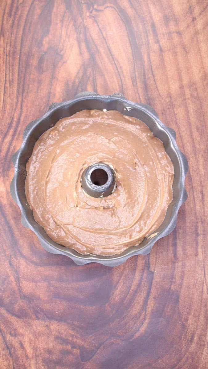 Top down view of a bundt pan filled with chocolate cake batter - Hostess At Heart