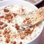Close view of a bowl of creamy gorgonzola cheese dip topped with crunchy chopped pecans. Hostess At Heart