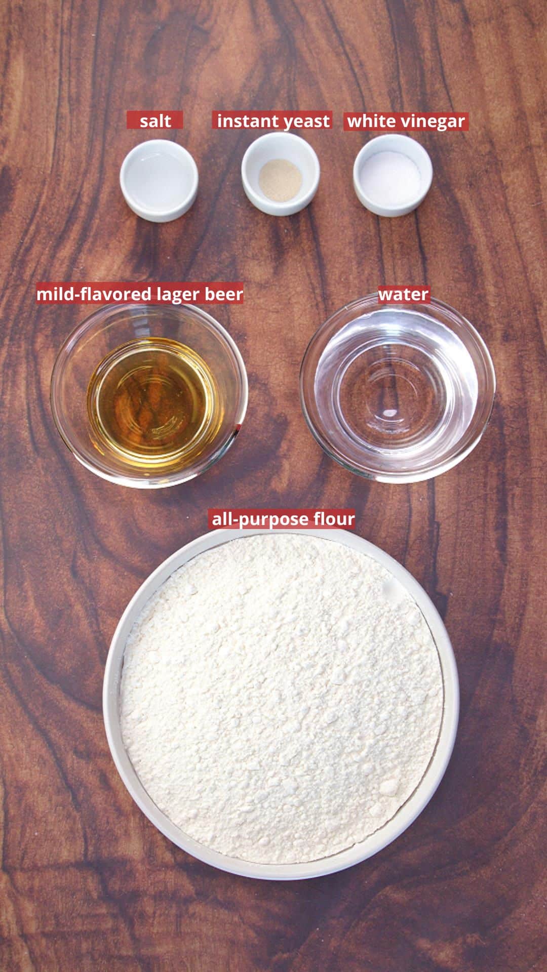 Ingredients for a dutch oven bread recipe: flour, beer, vinegar, salt, water, and yeast