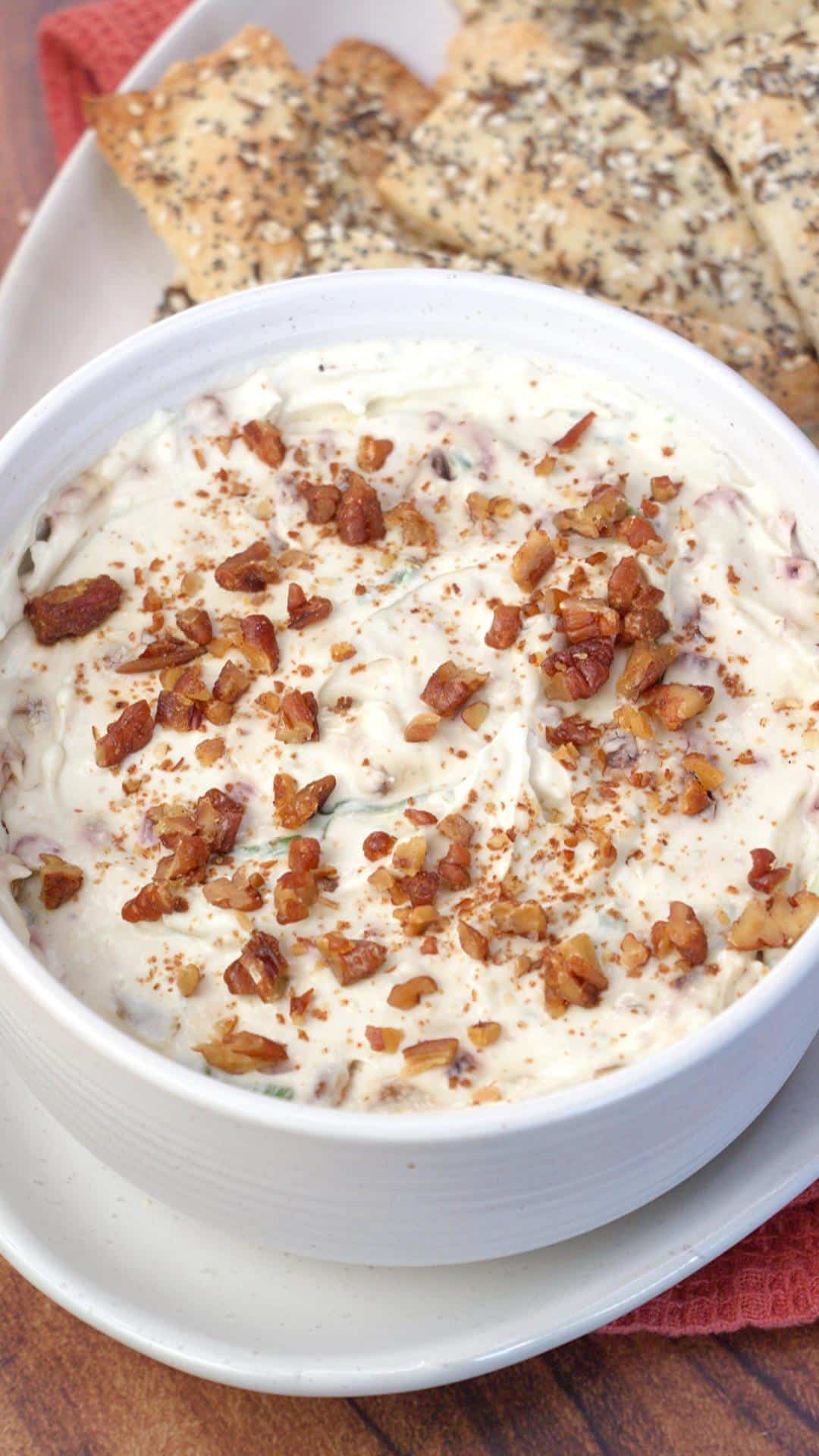 Beautiful gorgonzola dip in a bowl with crackers on the side.