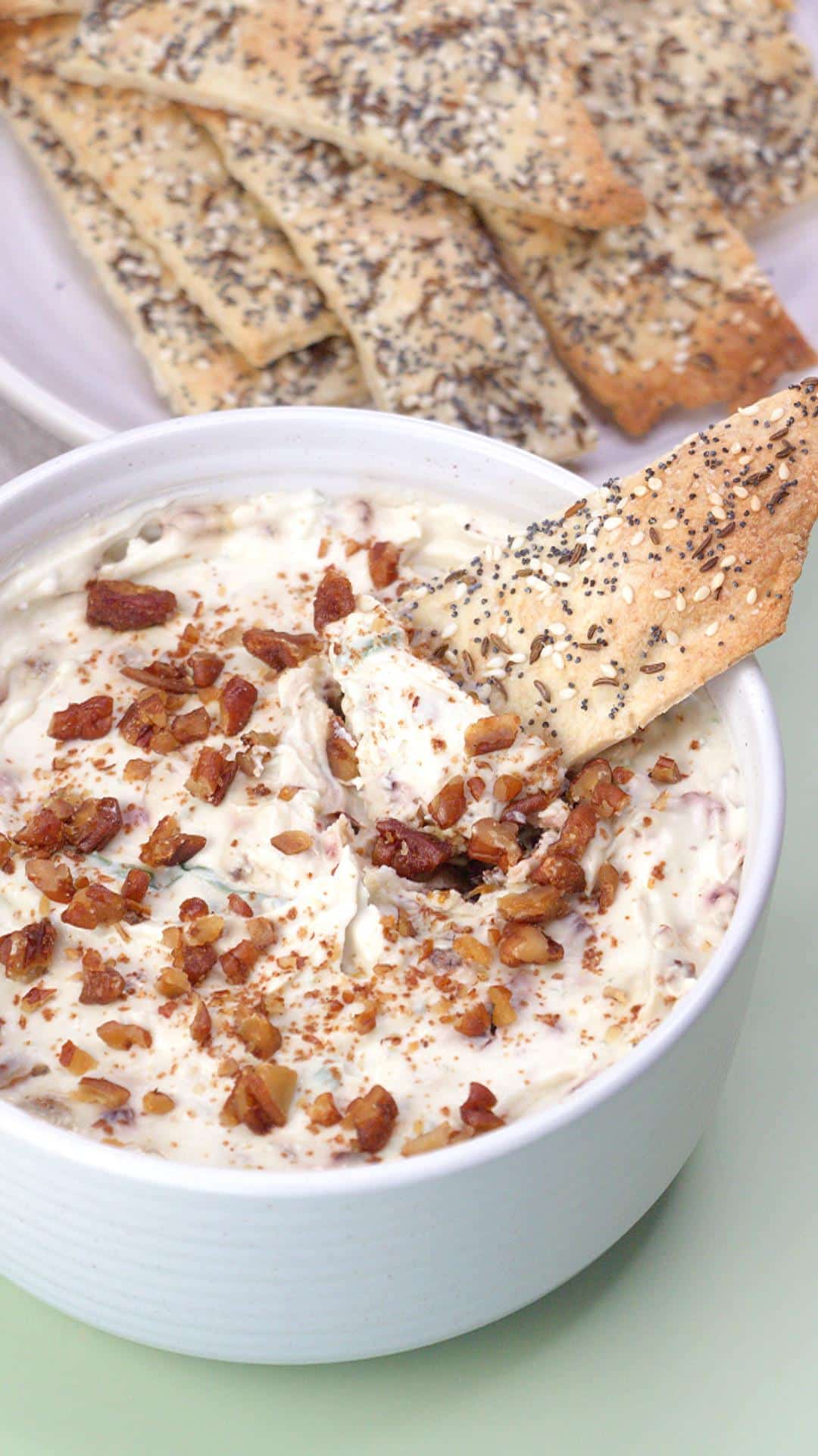 Gorgonzola spread with crackers dipping in.