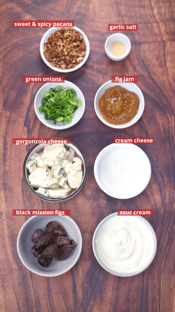 Ingredients for our Gorgonzola Cheese Dip recipe: sweet and spicy pecans, garlic salt, green onions, fig jam, gorgonzola cheese, cream cheese, black mission figs, and sour cream.
