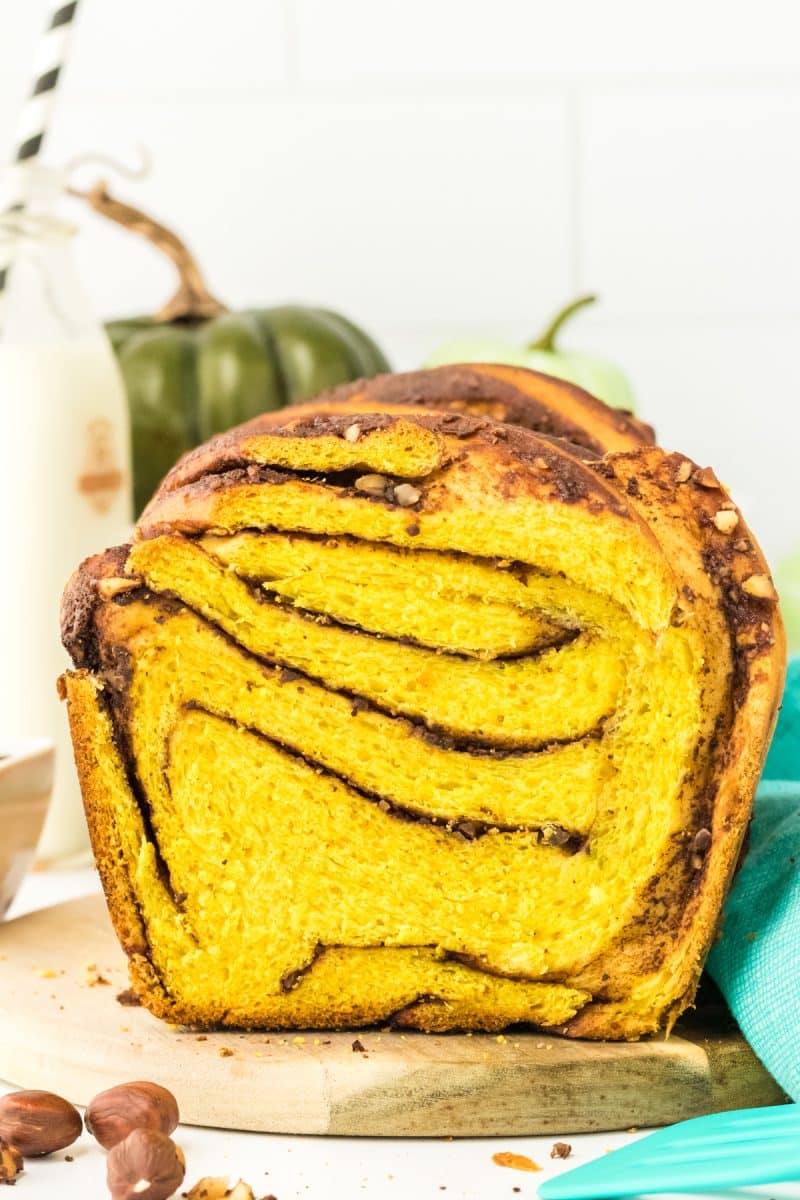 Front view of a loaf of chocolate nutella filled pumpkin babka bread showing the chocolate and crushed hazelnut swirls - Hostess At Heart