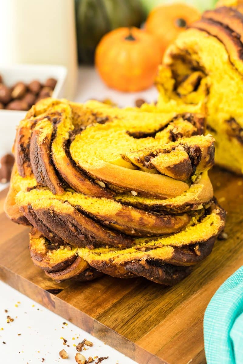 Slices of hazelnut filled chocolate pumpkin babka bread stacked on top of each other - Hostess At Heart