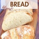 An image for Pinterest of an artisan loaf of bread that's been sliced on a cutting board - Hostess At Heart