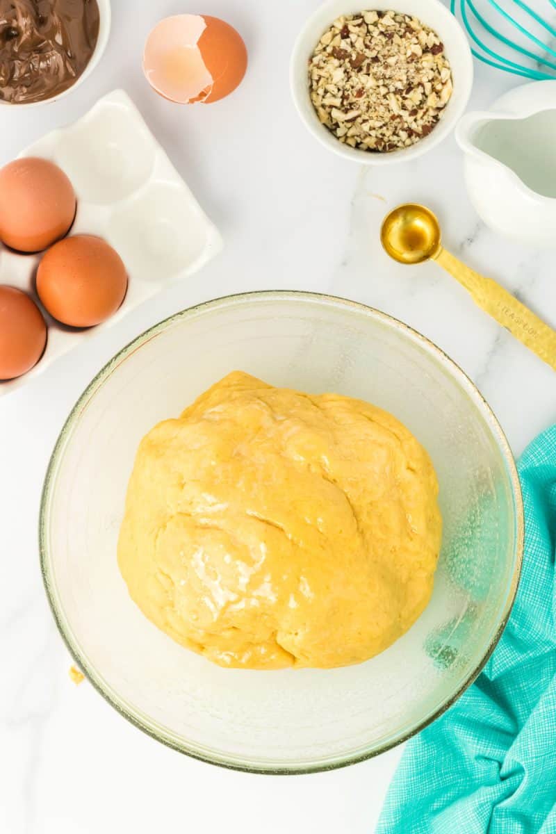 A ball of pumpkin hazelnut bobka bread dough in a mixing bowl - Hostess At Heart
