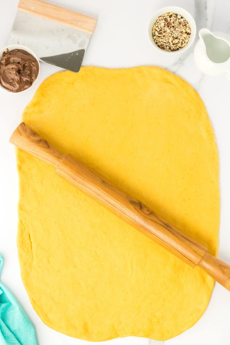 Top down view of rolled out bread dough in the shape of a rectangle. Hostess At Heart
