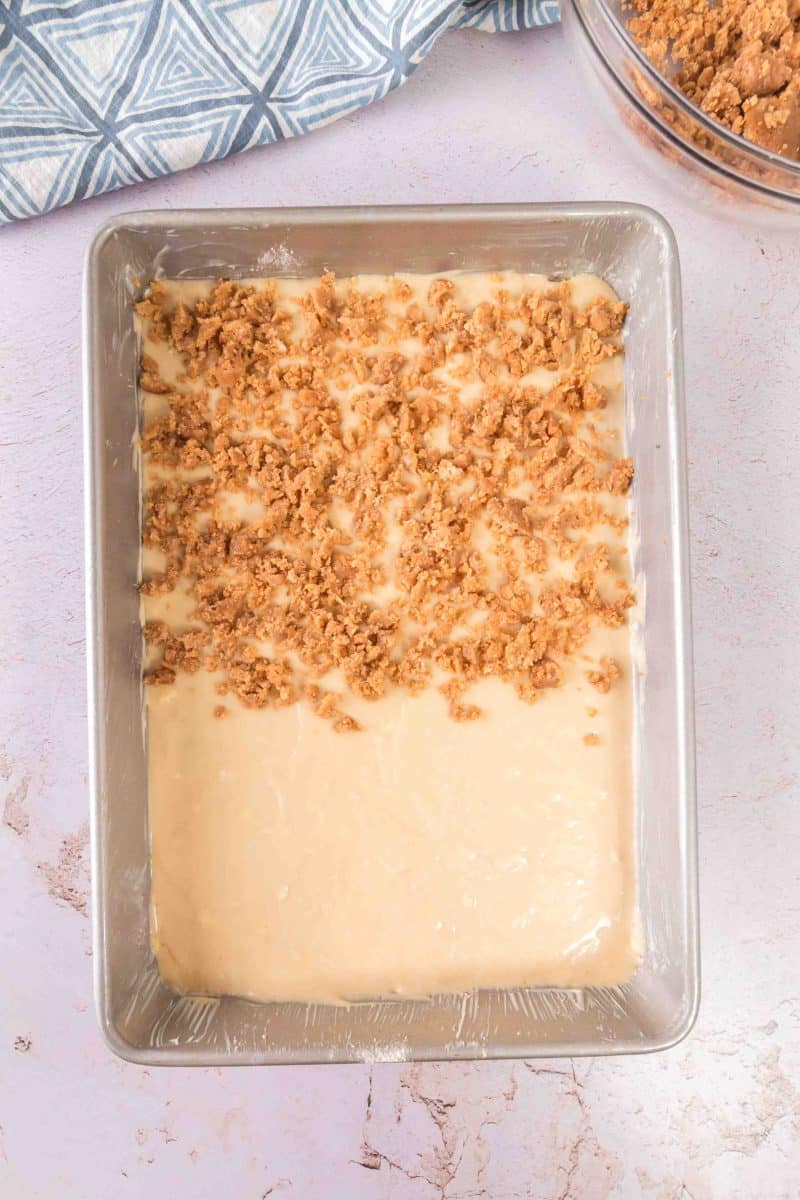 Spreading the coffee cake in the pan and topping it with the crumble.