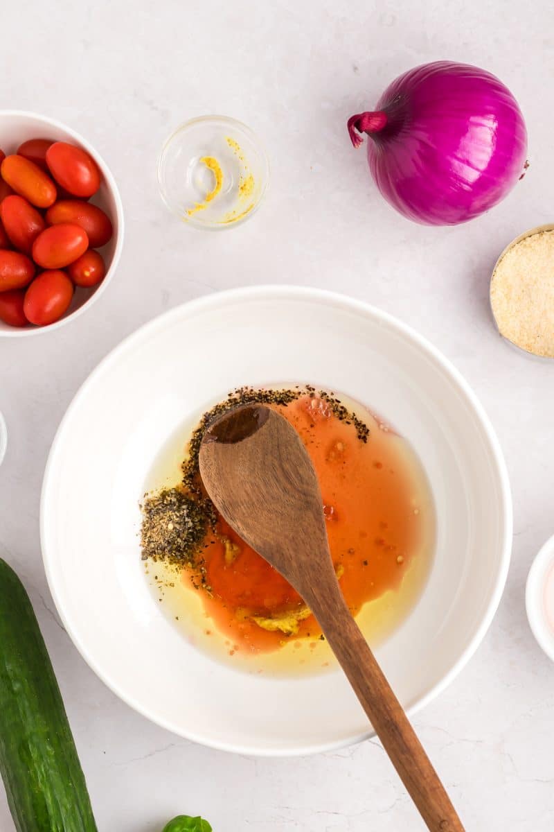 Top down view of a bowl filled with tortellini salad vinaigrette. Hostess At Heart
