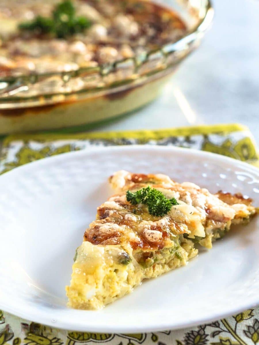 Close-up table view of a slice of crustless asparagus quiche - Hostess AT Heart