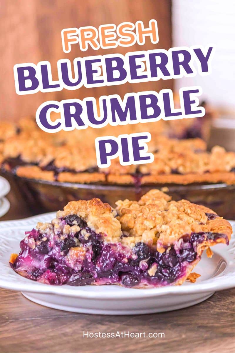 An image for Pinterest of a slice of blueberry crumble pie sitting in front of the baked pie.