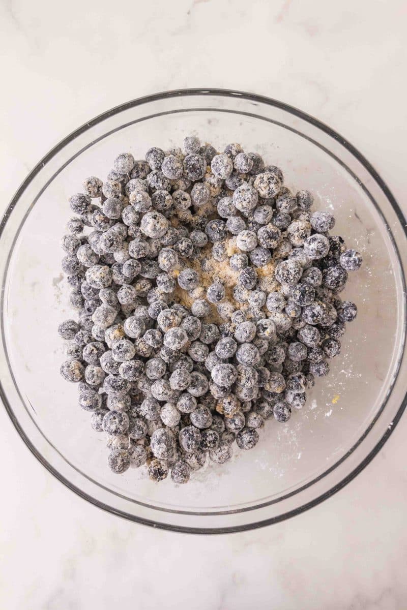 A bowl of fresh blueberries that have been coated with a cornstarch mix in order to thicken them when baked into a pie. Hostess At Heart