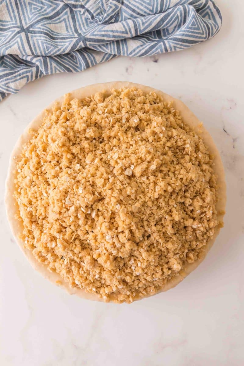 Top down view of a pie topped with a streusel topping. Hostess At Heart