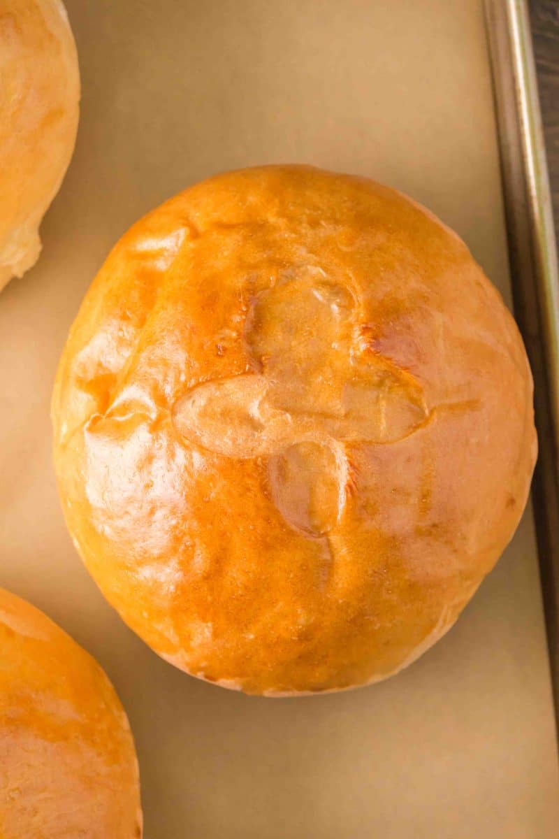 Top down view of a baked golden brown roll - Hostess At Heart