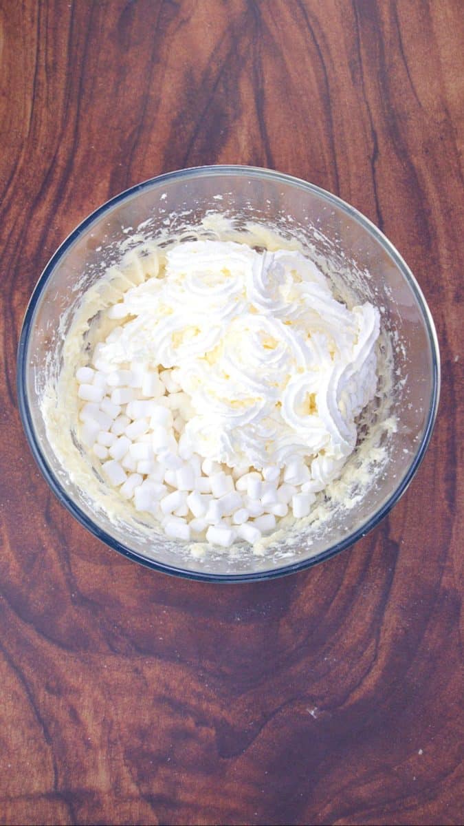 A bowl of a whipped cream cheese mixture topped with mini marshmallows - Hostess At Heart