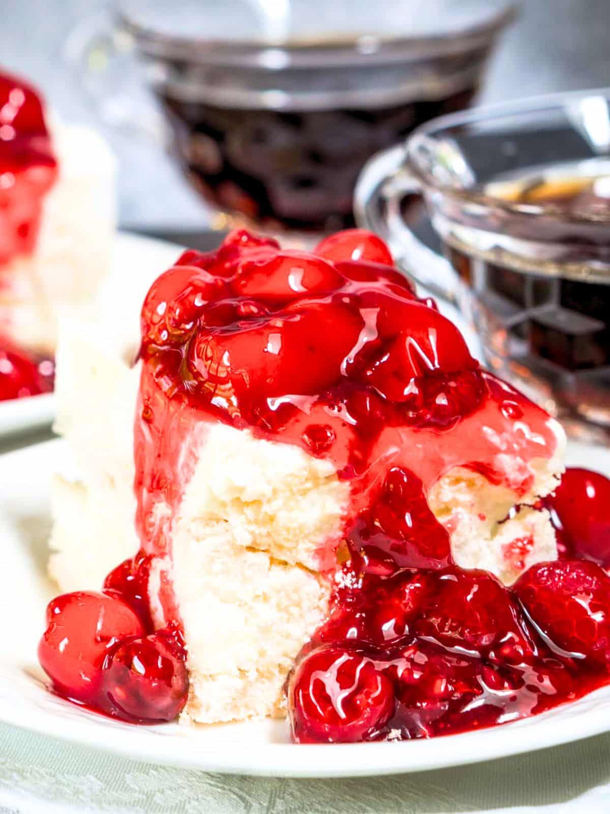 Tableview of soft tender baked meringue topped with a sweet cream cheese layer and a thick cherry raspberry filling - Hostess At Heart
