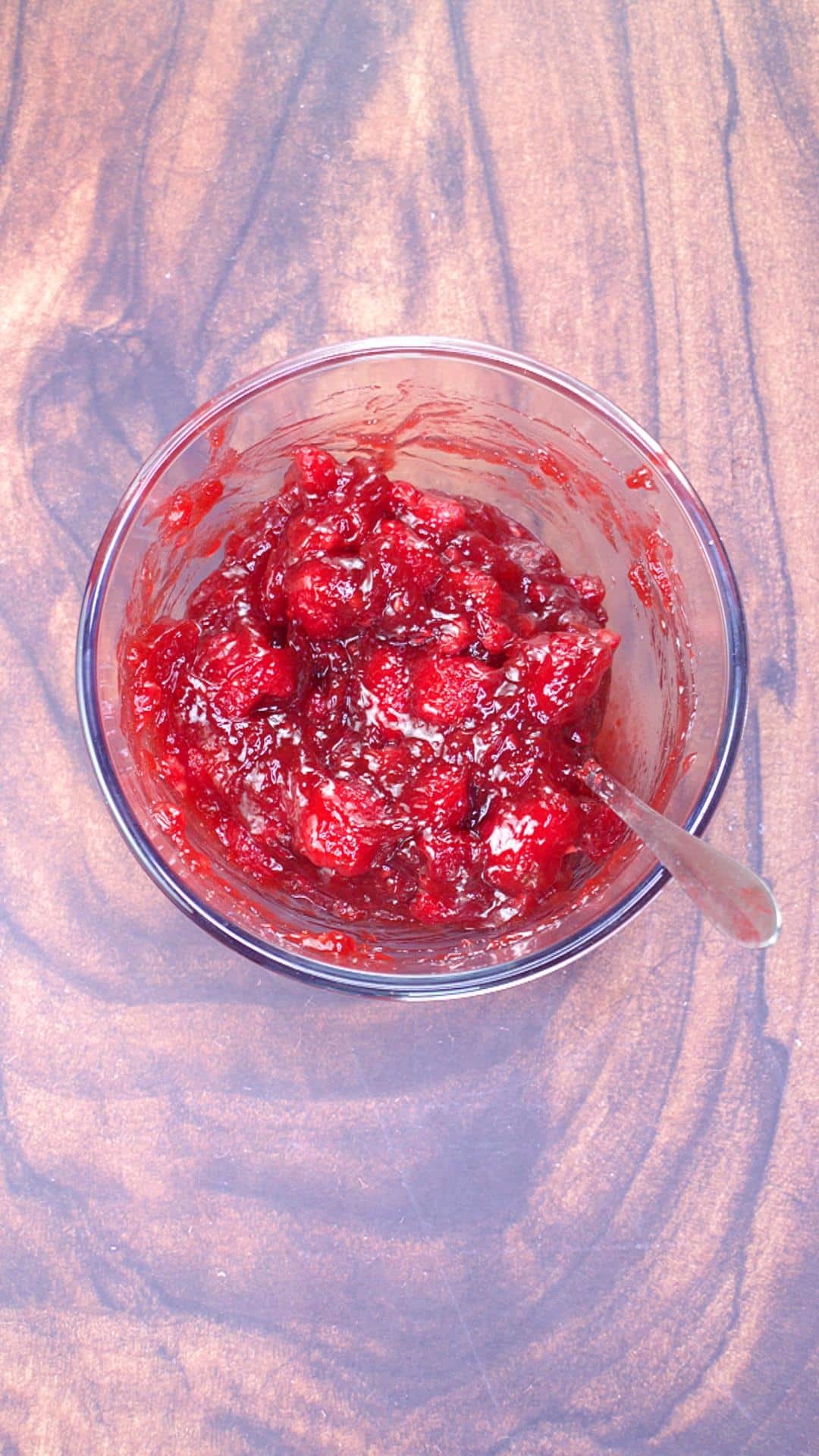 Cherry pie filling mixed with red raspberries in a mixing bowl - Hostess At Heart