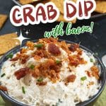 Angled side image of a bowl filled with a creamy crab dip topped with bacon crumbles and chopped chives. Hostess At Heart