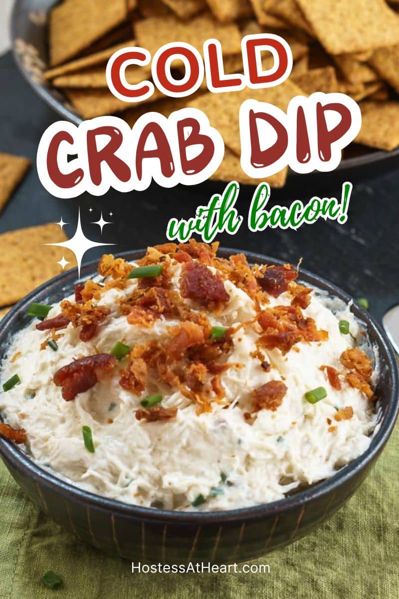 Angled side image of a bowl filled with a creamy crab dip topped with bacon crumbles and chopped chives. Hostess At Heart