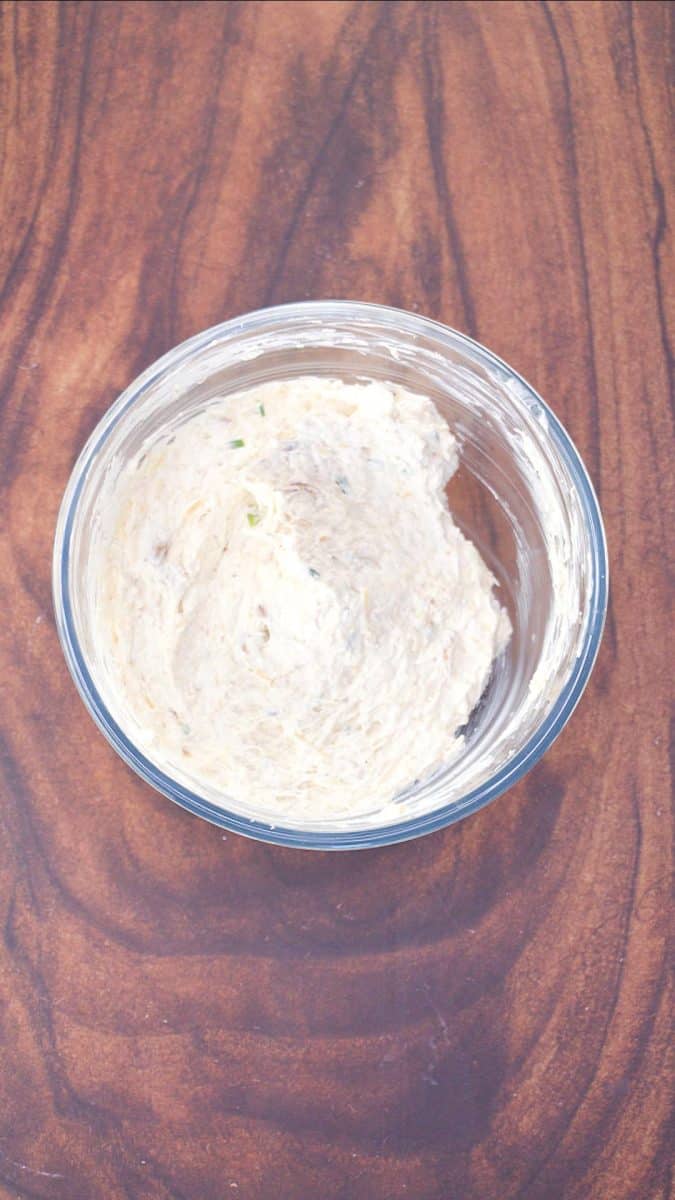 Mixing bowl filled with a creamy blend of Neufchatel and Parmesan cheese, chives, and old bay seasoning. Hostess At Heart