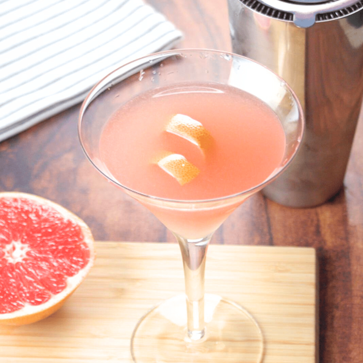Angled view of a martini glass filled with a grapefruit cocktail - Hostess At Heart
