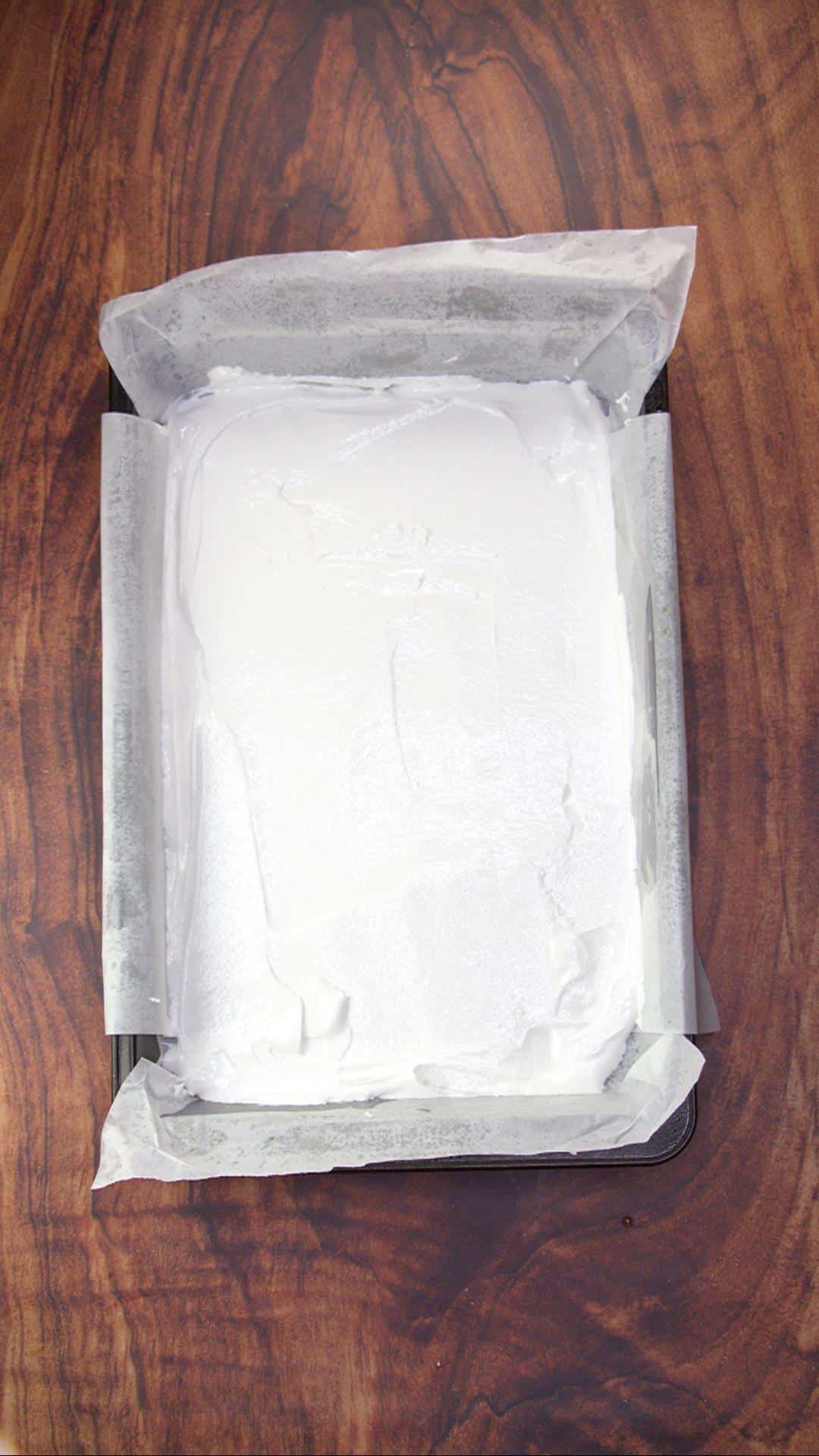 Whipped egg whites in a baking dish lined with parchment paper - Hostess At Heart