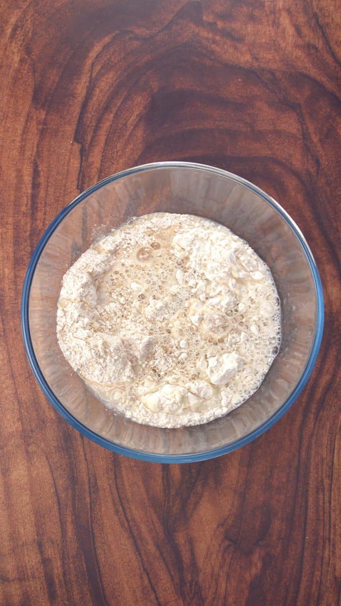 Water, flour, and yeast added to a bowl to make a sponge for bread baking - Hostess At Heart