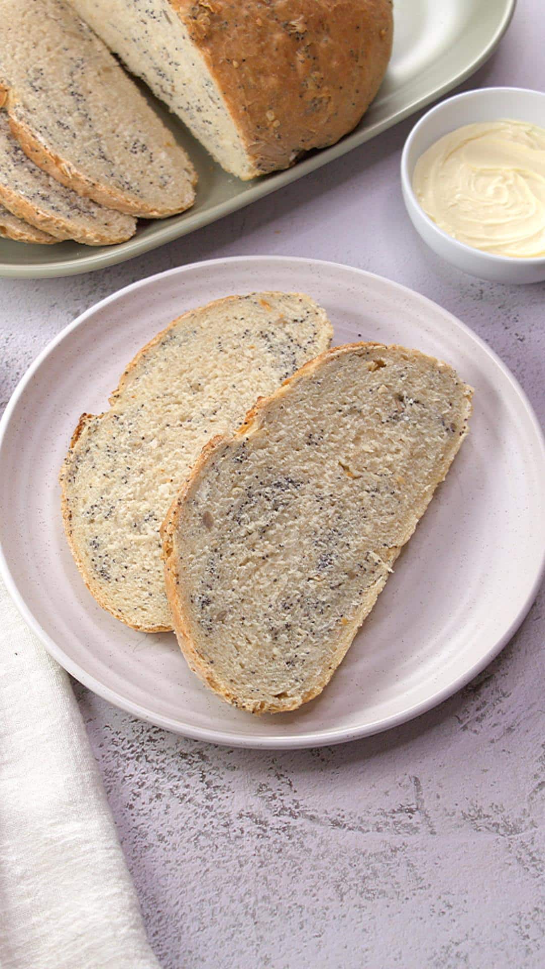 Top down view of a plate of sliced easy pumpernickel bread. - Hostess At Heart