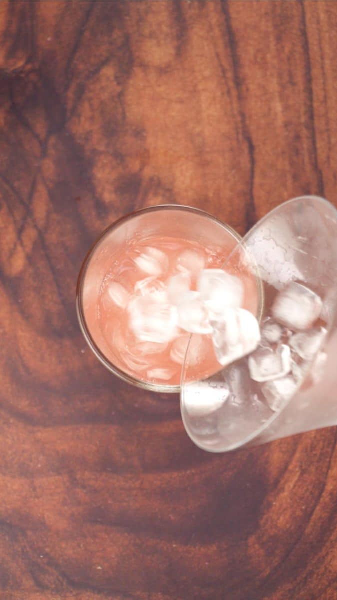Crush iced poured over a grapefruit martini cocktail in a shaker - Hostess At Heart