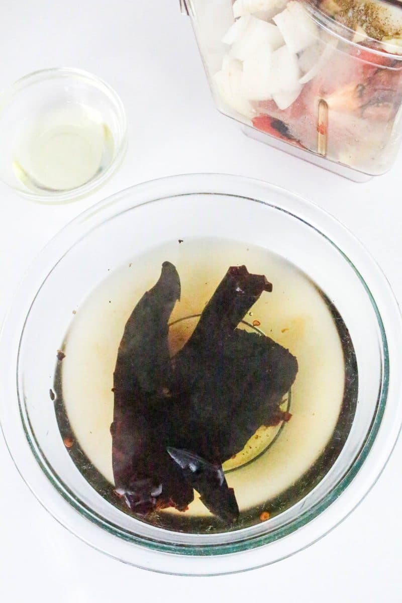 Roasted dried peppers soaking in a bowl of water. Hostess At Heart
