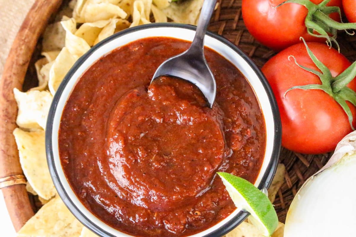 A bowl of thick dried chile salsa rojo surrounded by tortilla chips for dipping - Hostess At Heart
