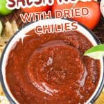 An image for Pinterest of a bowl of salsa rojo surrounded by tortilla chips - Hostess At Heart