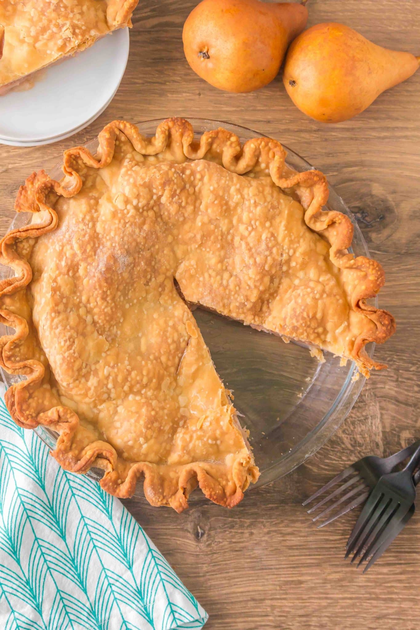 Top down view of a beautiful golden brown baked pie with a slice missing - Hostess At Heart